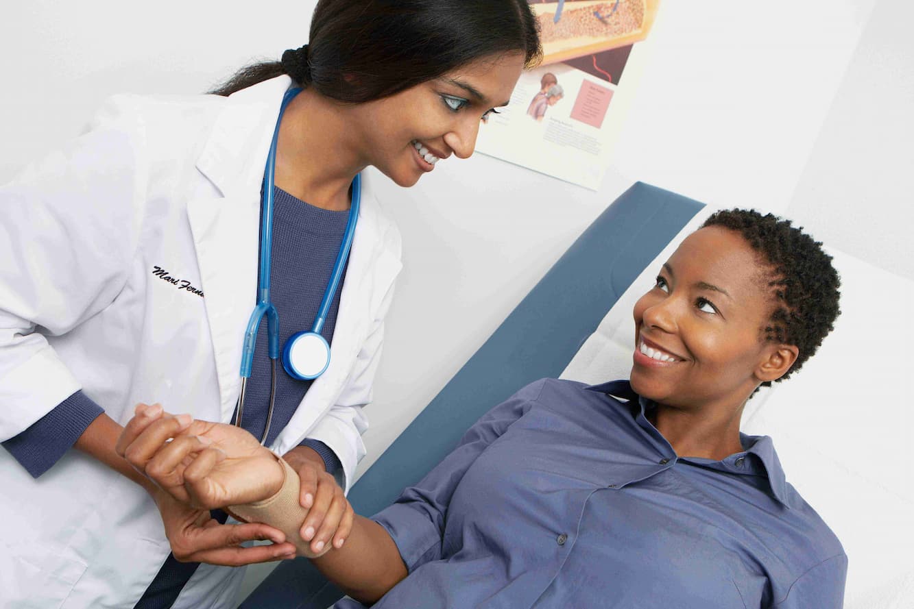 a doctor checking a patient's pulse